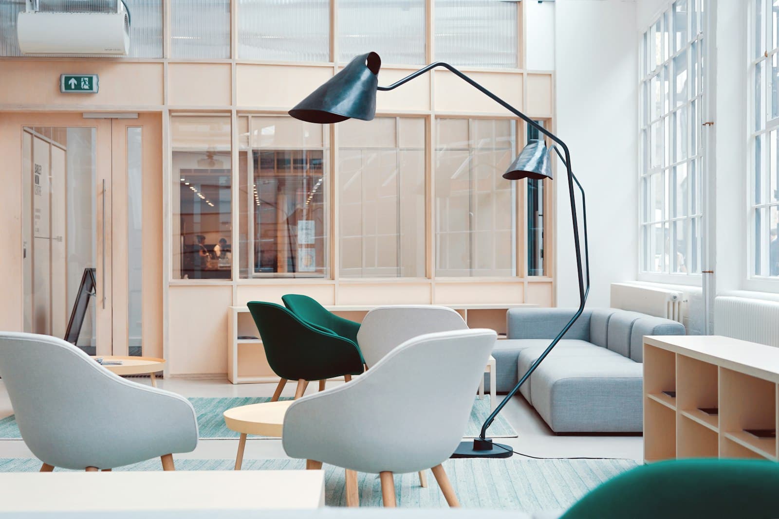 A calm, light-filled lounge interior with armchairs and a sofa.