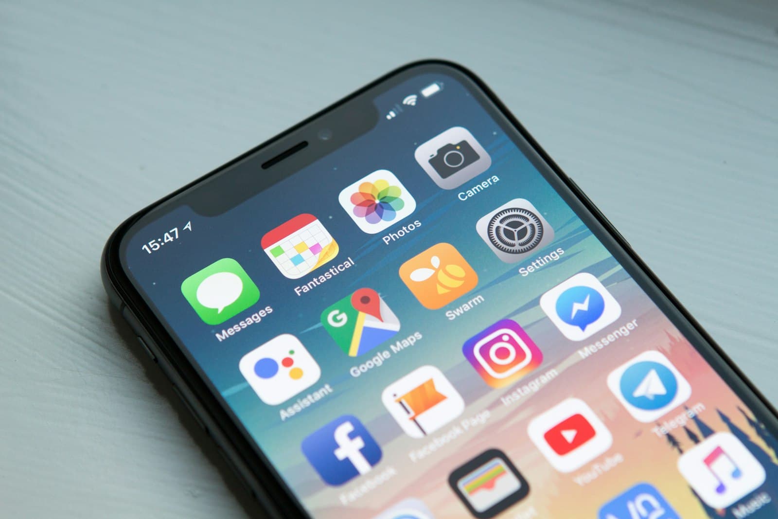 A close-up of a smartphone home screen filled with colourful app icons.