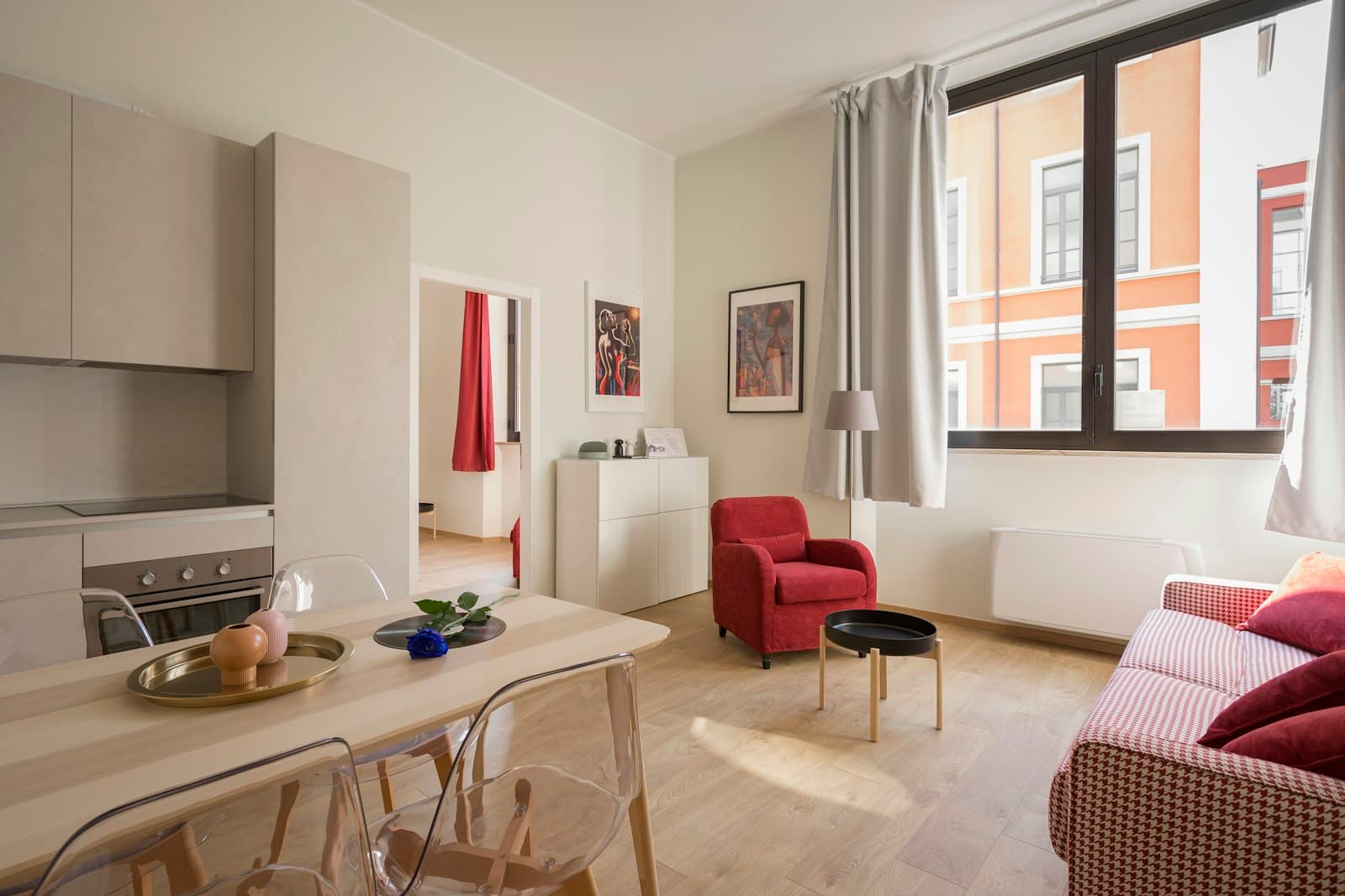 A bright, tidy apartment interior with a small dining table and kitchen.