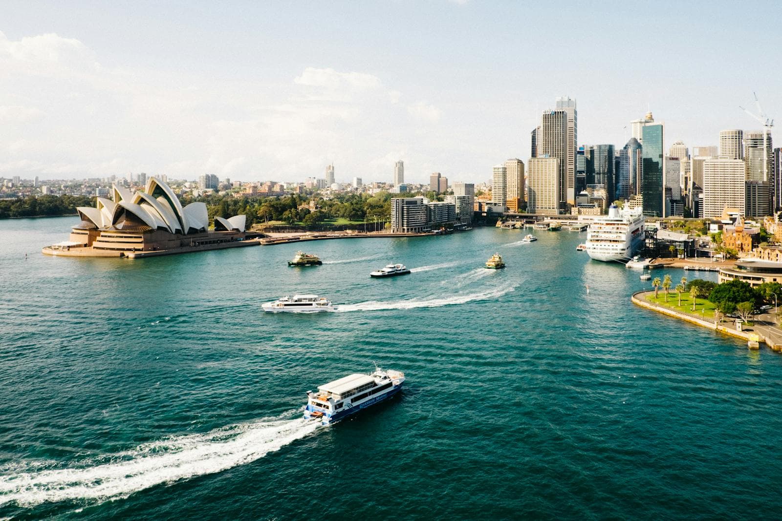 Ferries crossing Sydney Harbour at Circular Quay with the city skyline behind.