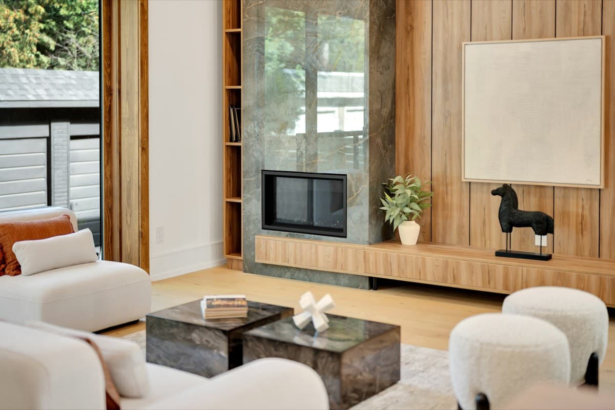 A contemporary Australian living room interior with a fireplace and considered furnishings.