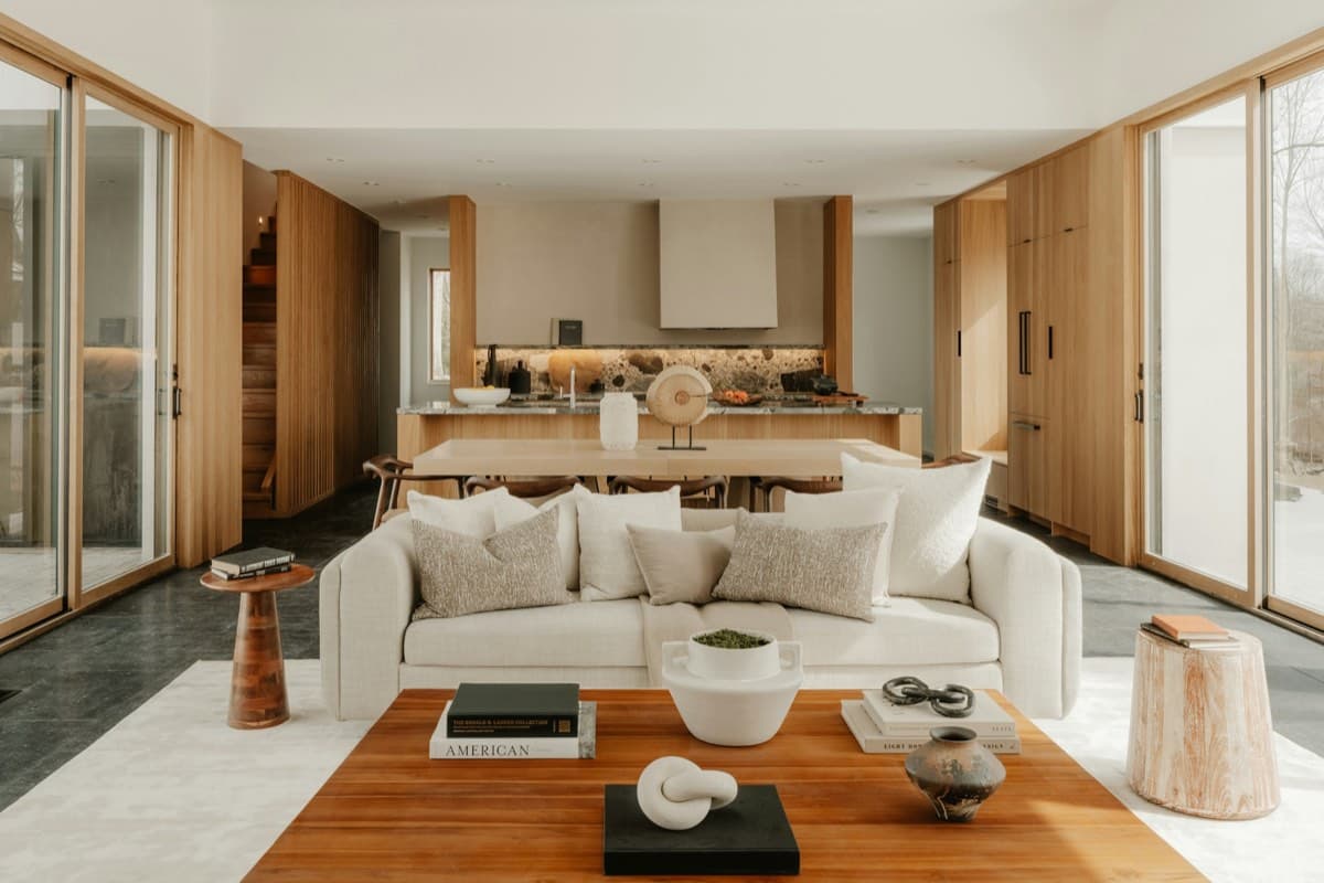 An open-plan Australian living room and kitchen with natural timber accents.