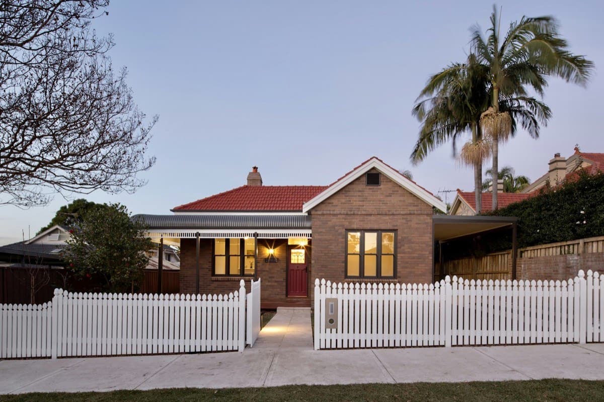 A freestanding Australian suburban investment property with a white picket fence.